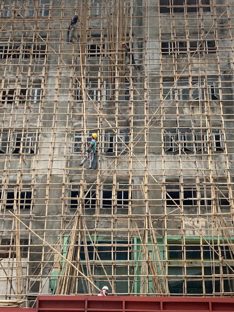 people walking on sidewalk near building during daytime